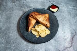 Sweet chilli Chicken sandwich with chips and mayo dip sauce served in plate isolated on background top view of breakfast food indian spices photo