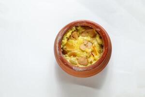 Firni, phirni anf kheer with nuts served in pot isolated on mat top view of indian, bangali and pakistani dessert mithai photo