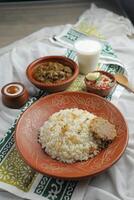 Mezbani Beef korma karahi khichuri rice Combo with salad, borhani and baked gulab jamun served in dish isolated on mat top view of indian and bangladeshi food photo