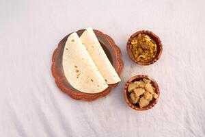 Desi nashta dal chicken, halwa and paratha served in dish isolated on background top view of bangladesi breakfast photo