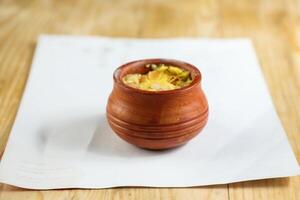 Firni, phirni anf kheer with nuts served in pot isolated on mat top view of indian, bangali and pakistani dessert mithai photo