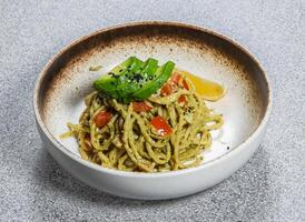 Avocado Spaghetti with tomato and lime served in dish isolated on background top view of taiwan food photo