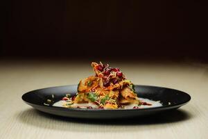 Doi Papri Chaat, papdi, dahi bhalla, bhallay, potato, crackers, masala and yogurt served in plate isolated on background top view of indian spices street food photo