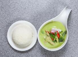 Chicken green curry with rice served in dish isolated on grey background top view of hong kong food photo