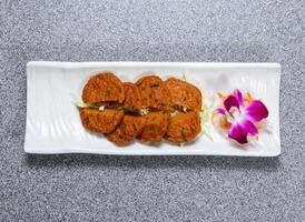 siamese fish cake served in dish isolated on grey background top view of hong kong food photo