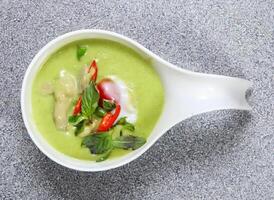 Chicken green curry with tomato served in dish isolated on grey background top view of hong kong food photo