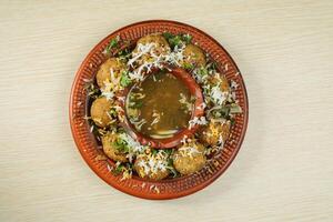 Fuchka or pani puri and gol gappay with sour water, served in dish isolated on table top view of indian, bangladeshi and pakistani street food photo