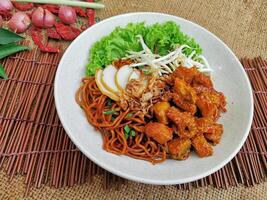 Chicken Curry Dry Noodle served dish isolated on table top view of thai food photo