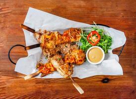 Skewers set satay with mayonnaise dip and salad served in dish isolated on wooden table top view of hong kong food photo