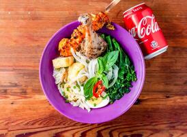 chicken noodle soup with skewer and coke can served in dish isolated on wooden table top view of hong kong food photo