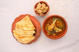 desi breakfast Mutton nalli nihari, Halwa and paratha served in dish isolated on background top view of bangladesi breakfast photo