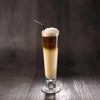 Kopi Cino or cappucino with straw served in glass isolated on table side view healthy morning drink photo