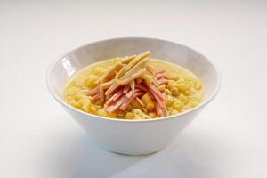 Imitation abalone and ham pasta served in bowl isolated on wooden table side view of hong kong fast food photo