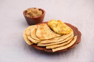 Desi breakfast omelet, halwa and paratha served in dish isolated on background top view of bangladesi breakfast photo