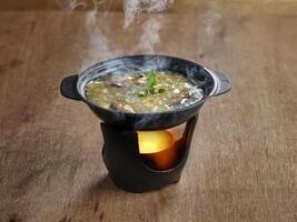 Shark Fin Soup served in stew dish isolated on table side view of soup photo