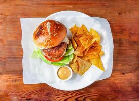 tandoori pork burger with cabbage, mayonnaise dip and crackers served in dish isolated on wooden table top view of hong kong food photo