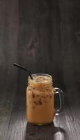 chocolate Ice Tea with straw served in mug isolated on table side view healthy morning drink photo