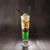 Cendol Sling shake with straw served in glass isolated on table side view healthy morning drink photo