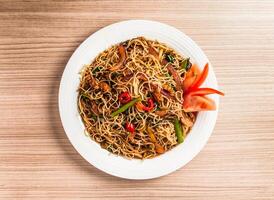 stewed rice vermicelli with pickled cabbage and shredded duck served in dish isolated on table top view of hong kong food photo