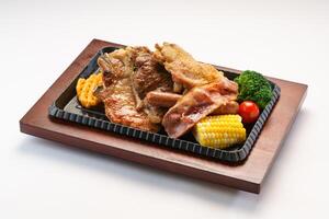 American chop with corn, broccoli and tomato served in dish isolated on wooden table side view of hong kong fast food photo