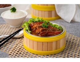 BRAISED PORK BELLY WITH TARO with chopsticks served in dish isolated on table top view of singapore food photo