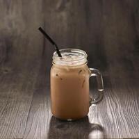 Ice Milo with straw served in mug isolated on table side view healthy morning drink photo