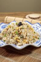 Black Truffle Fried Rice with chopsticks served in dish isolated on mat top view on wooden table Hong Kong food photo