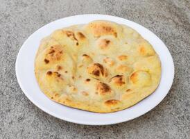 tandoori naan, roti and pita bread served in dish isolated on background top view of indian spices and pakistani food photo