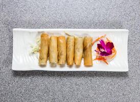 thai spring roll served in dish isolated on grey background top view of hong kong food photo