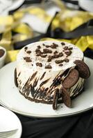 Oreo Cheesecake include chocolate, cream, sugar with fork and flowers served in plate isolated on napkin side view of cafe food photo