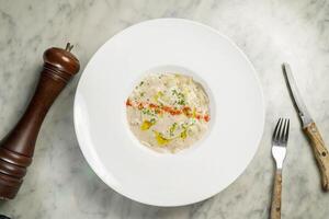 Ravioles Du Royans Sauce Truffe served in dish isolated on marble background top view on hong kong food photo