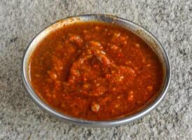 Spicy and sweet Chutney or sauce served in dish isolated on grey background side view of indian spices and pakistani food photo