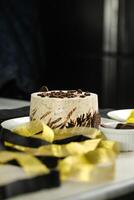 Oreo Cheesecake include chocolate, cream, sugar with fork and flowers served in plate isolated on napkin side view of cafe food photo