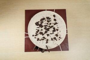 Oreo Cheesecake include chocolate, cream, sugar with fork and flowers served on board isolated on napkin top view of cafe food photo