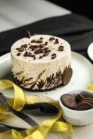 Oreo Cheesecake include chocolate, cream, sugar with fork and flowers served in plate isolated on napkin side view of cafe food photo