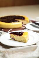 Blueberry Cheesecake slice include caramel with fork and knife served in plate isolated on table top view of cafe bake food photo