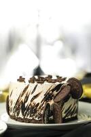 Oreo Cheesecake include chocolate, cream, sugar with fork and flowers served in plate isolated on napkin side view of cafe food photo