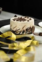 Oreo Cheesecake include chocolate, cream, sugar with fork and flowers served in plate isolated on napkin side view of cafe food photo