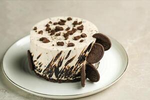 Oreo Cheesecake include chocolate, cream, sugar with fork and flowers served in plate isolated on napkin side view of cafe food photo