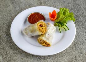 chicken bihari roll with chutney served in dish isolated on grey background side view of indian spices and pakistani food photo