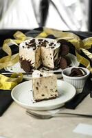 Oreo Cheesecake slice include chocolate, cream, sugar with fork and flowers served in plate isolated on napkin side view of cafe food photo