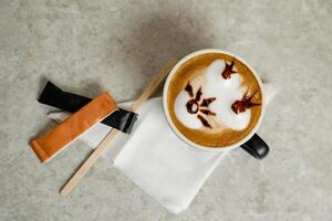 Art Coffee served in cup with sugar packet isolated on tissue top view cafe breakfast drink photo