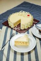 Vanilla Cake slice include cream, sugar, red berry served in plate isolated on napkin side view of cafe food photo