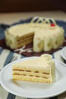 Vanilla Cake slice include cream, sugar, red berry served in plate isolated on napkin side view of cafe food photo