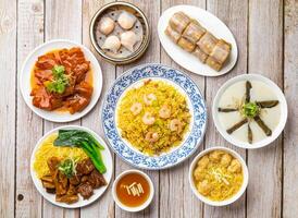 salted lean pork and preserved egg congee, rice noodle rolls filled with twisted cruller, shrimp fried rice, steam shrimp dumplings, pig feet beancurd, wonton noodles soup isolated hong kong food photo