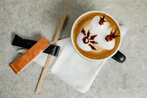 Art Coffee served in cup with sugar packet isolated on tissue top view cafe breakfast drink photo