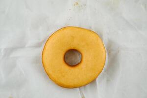 Plain donut isolated on grey background top view of baked food breakfast on table photo