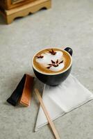 Art Coffee served in cup with sugar packet isolated on tissue side view cafe breakfast drink photo