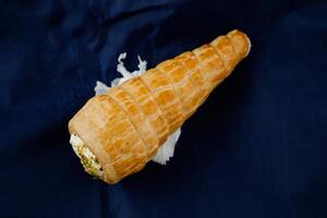 Cream Roll or cream buns isolated on blue napkin top view of french breakfast baked food item photo