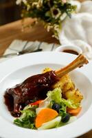 Lamb Ossobuco or Osso buco lamb shanks with potato, dip and salad served on plate isolated on napkin side view of meat food photo
